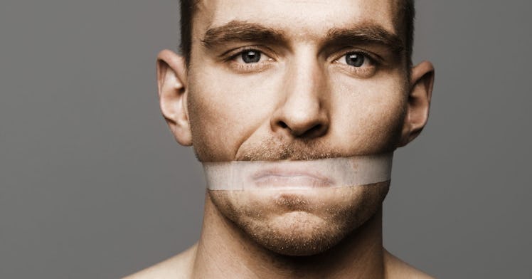 A man has his mouth taped shut.