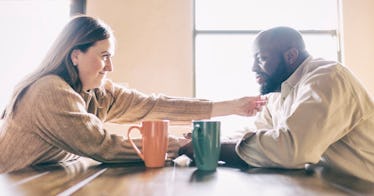 Couple drinking coffee and staring at each other lovingly