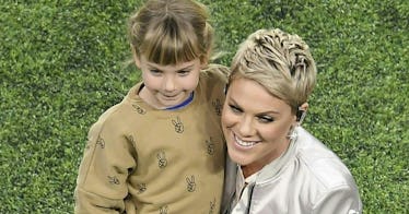 Pink and her daughter, Willow, stand on a football field