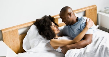 Happy_couple_laughing_in_bed