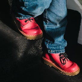 Close up on a 30-month-old's feet in red shoes descending the stairs.