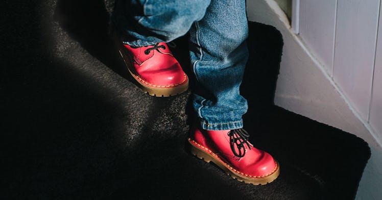 Close up on a 30-month-old's feet in red shoes descending the stairs.