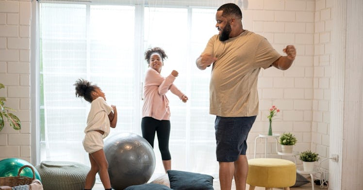 a dad and his two kids stretch after a family-friendly workout