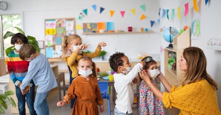 a group of young children are masked and not masked