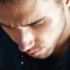 A man drips sweat during a workout.