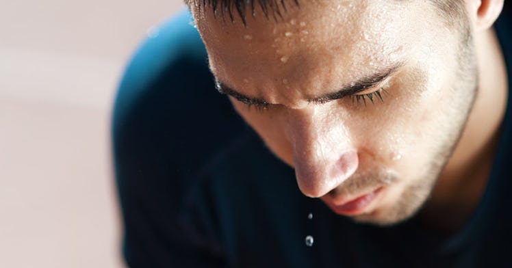 A man drips sweat during a workout.