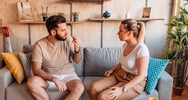 Couple sitting on couch having an argument