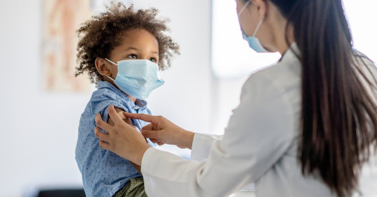A young kid receives a COVID vaccine.