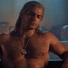 Henry Cavill, with well-groomed chest hair sits in a bath as the character Geralt from The Witcher.
