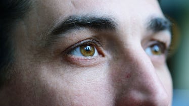 Close up shot of man's brown eyes as he stares into the distance