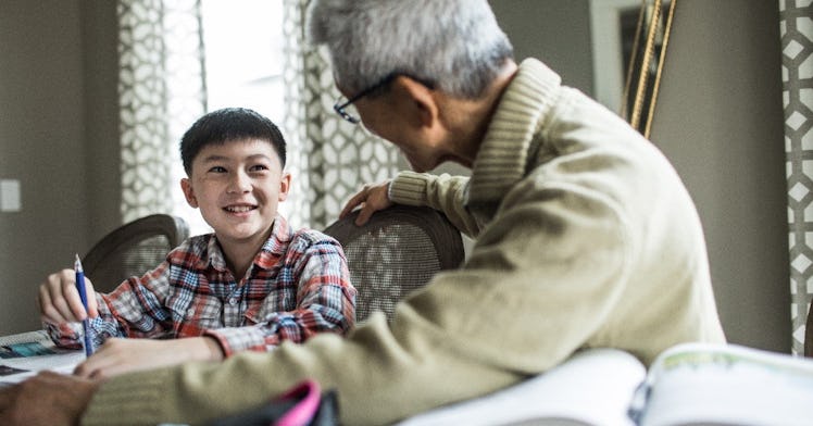 a grandson and his grandad look at one another, and smile