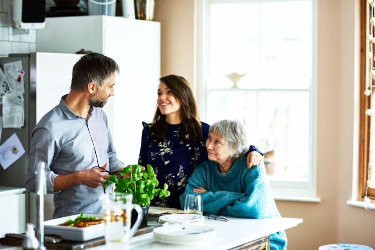 Husband and wife in kitchen with mother-in-law