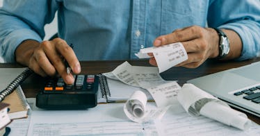 A man checking receipts, filing his taxes.