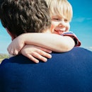 Boy hugging his dad.