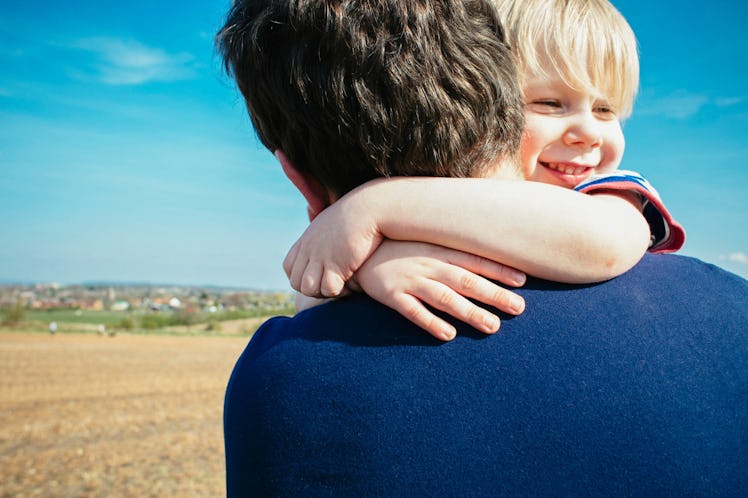 Boy hugging his dad.