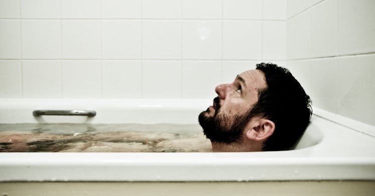 A man takes a post-workout ice bath.