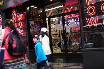 NEW YORK, NY - AUGUST 07: Pedestrians walk by one of the few remaining adult DVD stores in Times Squ...
