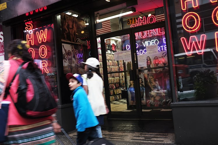 NEW YORK, NY - AUGUST 07: Pedestrians walk by one of the few remaining adult DVD stores in Times Squ...