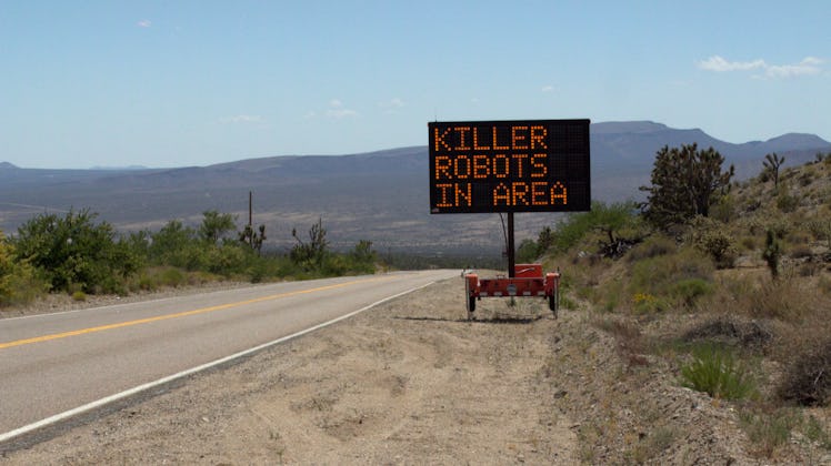 "Killer robots in area" text sign next to a road