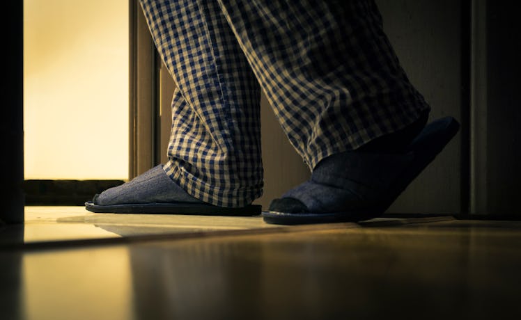 An individual visiting the restroom during the nighttime.