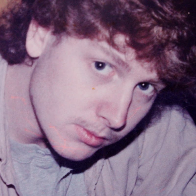 A close-up portrait of Timothy L. Tyler posing and looking up