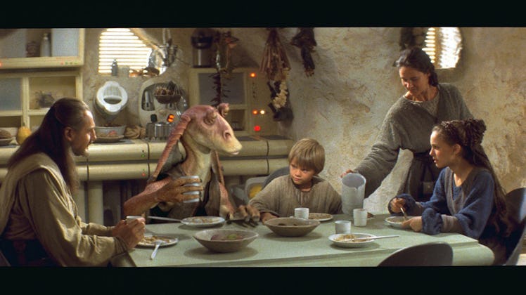 Jar Jar Binks sitting at a dining table in a Star Wars scene