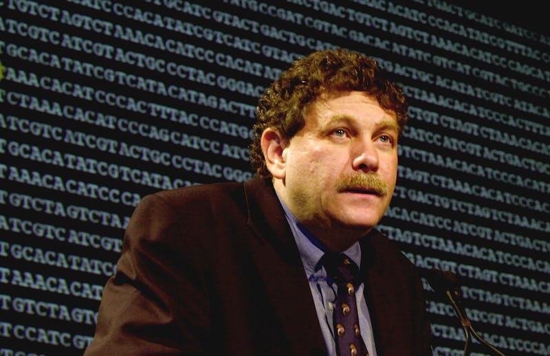 Eric Lander sitting during a press conference