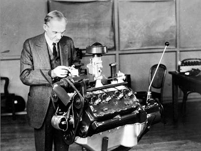 An old photograph with Henry Ford assembling one of his inventions