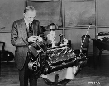 An old photograph with Henry Ford assembling one of his inventions