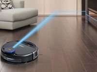 A black robot vacuum cleaner on floor