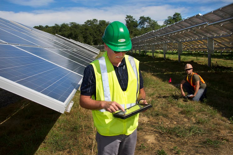 Worker maintaining solar panels of Long Island Solar Farm