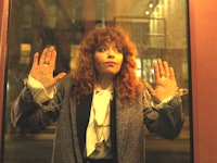 Natasha Lyonne in Russian Doll leaning against a glass door with her hands and face