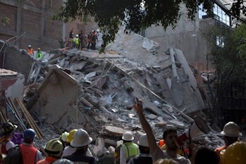 MEXICO CITY, MEXICO - SEPTEMBER 19: Rescuers work in the rubble after a magnitude 7.1 earthquake str...