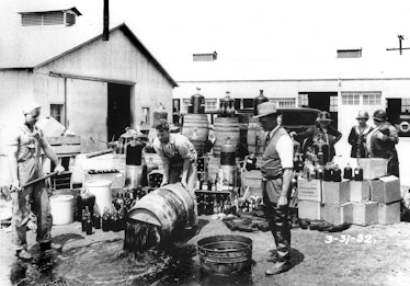 Orange County Sheriff’s deputies dump illegal booze in Santa Ana, Calif. in this 1932 photograph. 