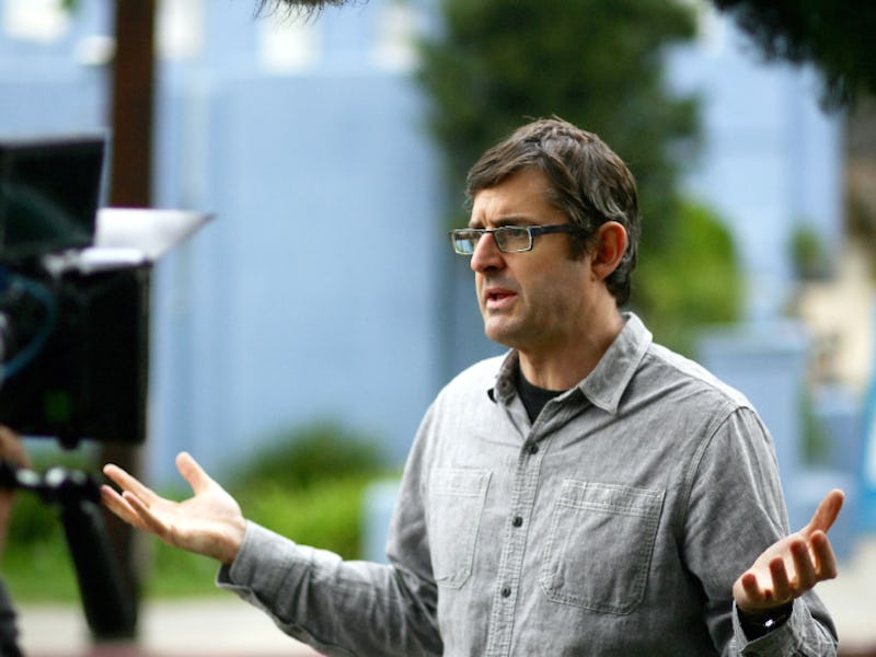 Louis Theroux in a grey shirt speaking with a camera filming him