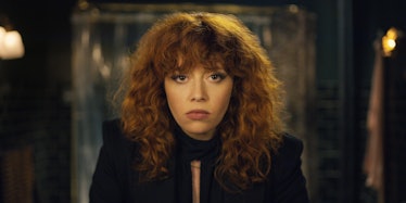Natasha Lyonne looking straight at the camera in a black suit in Russian Doll