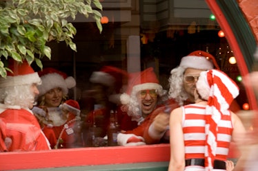 Mr. and Ms. Claus kissing through a window