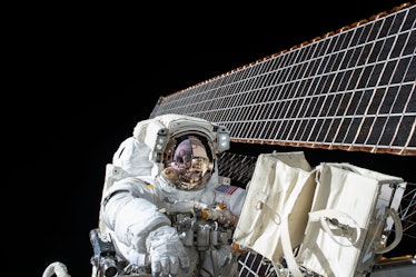 An astronaut working on the satellite in space