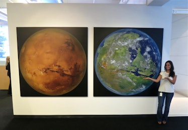 SpaceX's front entrance lobby shows a large picture of Mars, next to an image of a hypothetical terr...