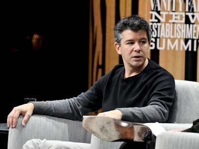Uber CEO Travis Kalanick sitting in an armchair