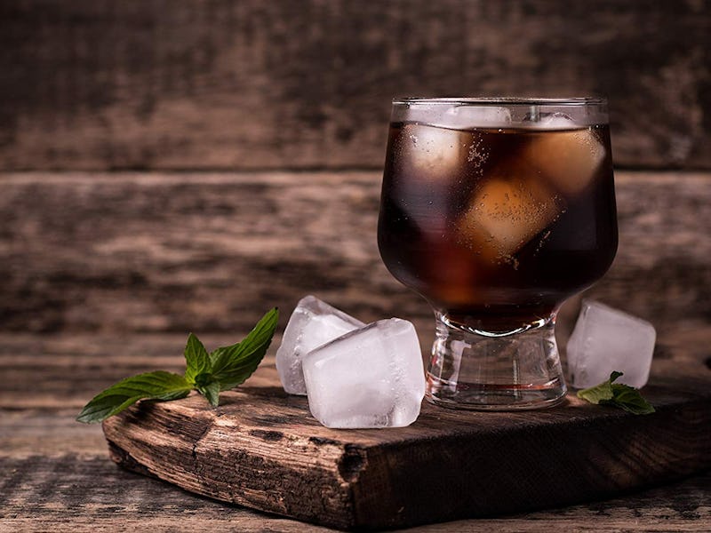 An ice coffee made with a cold-brew coffee maker for under 30$ on a wooden board topped with ice