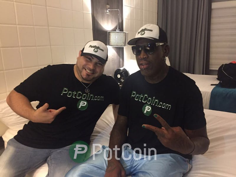 Dennis Rodman and his friend, both sporting 'Potcoin' tees, sitting in a North Korean hotel room.