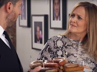 A waiter offering sausages to Samantha Bee 