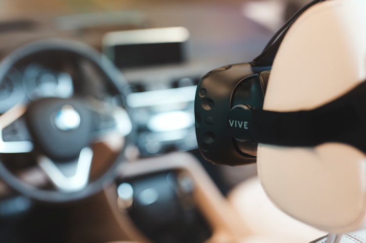 The HTC Vive facing a steering wheel.