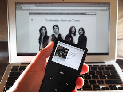 The Beatles song on opened iTunes app on iPad and on a Macbook in the background