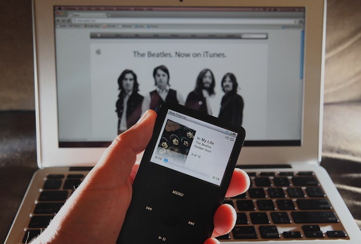 The Beatles song on opened iTunes app on iPad and on a Macbook in the background