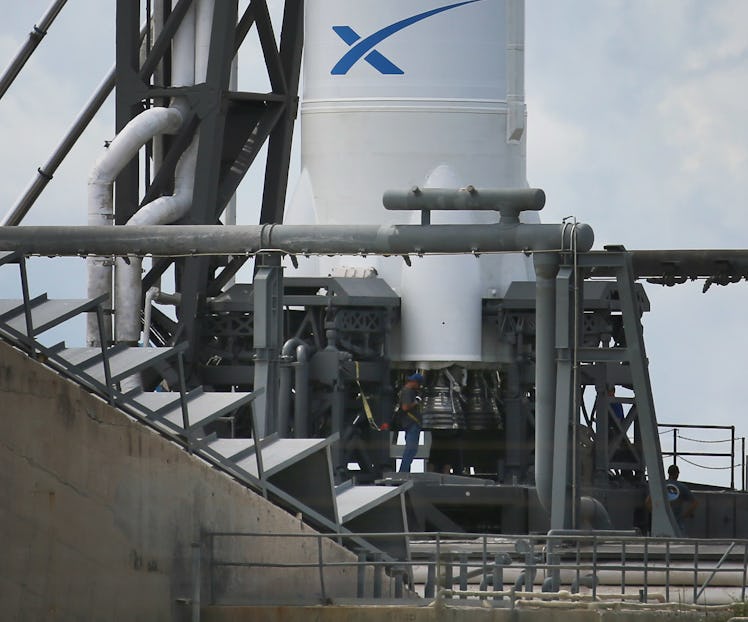 CAPE CANAVERAL, FL - OCTOBER 07: A worker is seen near the engines for the SpaceX Falcon 9 rocket at...