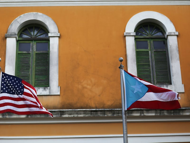 An orange building with the American and Puerto Rican flags hanged on it