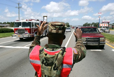 PENSACOLA, FL - JULY 11: US National Guardsman Sgt. Robert Gaines directs traffic July 11, 2005 in i...