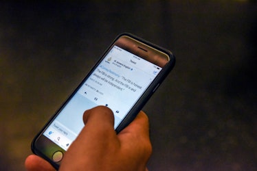 NEW YORK, NY - JUNE 8: A person reads Tweets while watching testimony from former FBI Director James...